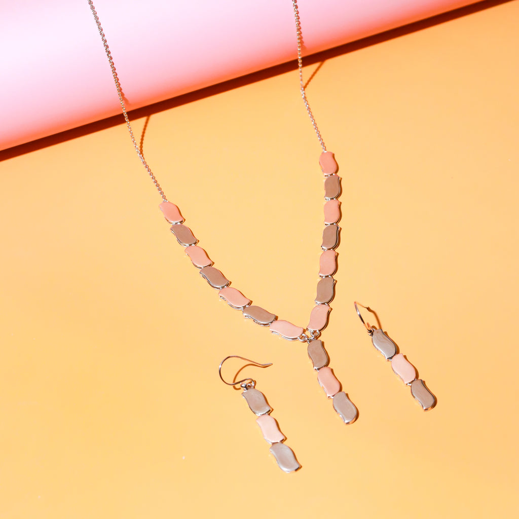 Rose gold pendant necklace set displayed on a white background
